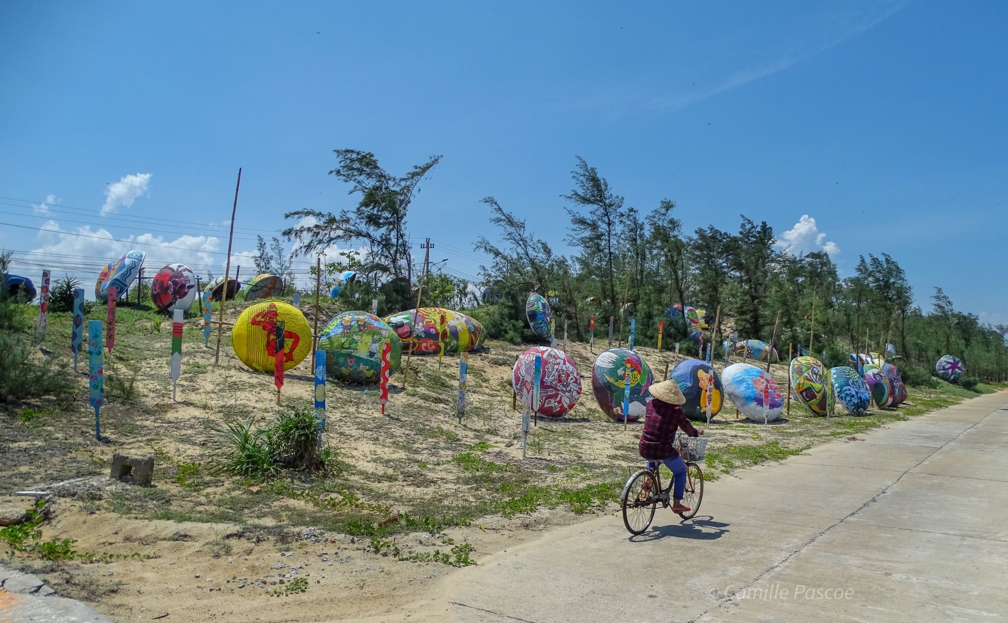 A woman riding along the round boat display at Tam Thanh Beach